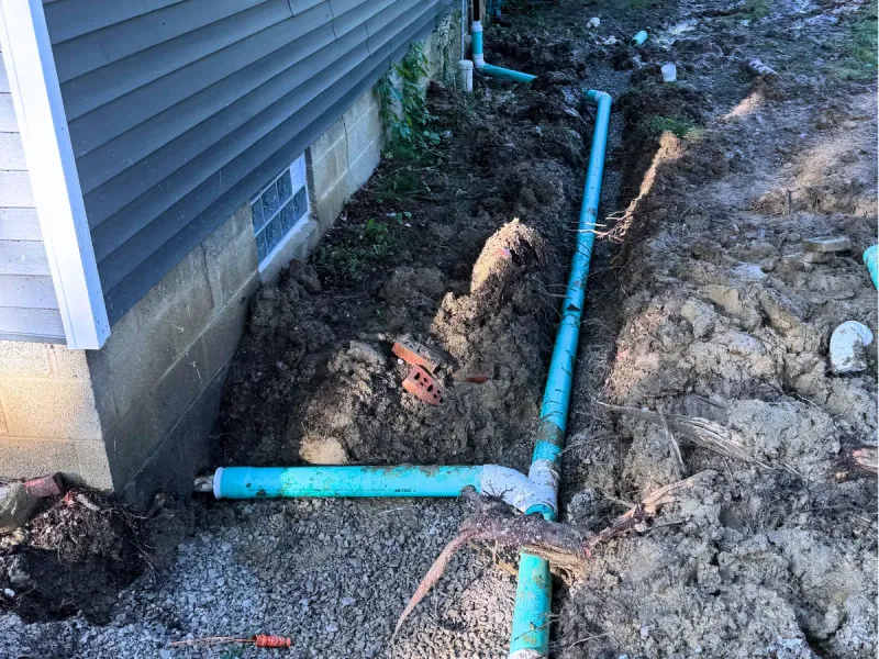 French drain and downspout tie-ins routing water away from a foundation near Avon
